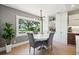Cozy dining area featuring a round table, comfortable chairs, and a large window with scenic outdoor views at 1467 Battalion Dr, James Island, SC 29412