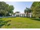 Charming single-story home with a well-manicured lawn, classic white facade, and lush green trees at 1467 Battalion Dr, James Island, SC 29412