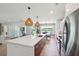 Bright, open kitchen with large island, modern stainless steel appliances, and stylish lighting at 1467 Battalion Dr, James Island, SC 29412
