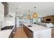 Bright, open kitchen with large island, modern stainless steel appliances, and stylish lighting at 1467 Battalion Dr, James Island, SC 29412
