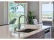 Close up of a kitchen island with a modern faucet and picturesque water view at 1467 Battalion Dr, James Island, SC 29412