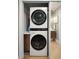 Laundry closet features stacked washer and dryer and a wood countertop at 1467 Battalion Dr, James Island, SC 29412