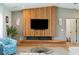Comfortable living room with a modern fireplace, wooden accent wall, stylish seating, and ample natural light at 1467 Battalion Dr, James Island, SC 29412