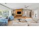 Spacious living room with herringbone floors, modern furniture, and a striking wooden feature wall with a fireplace at 1467 Battalion Dr, James Island, SC 29412