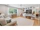 Bright living room with a large window, decorative shelving, and a cozy couch with a patterned rug at 1467 Battalion Dr, James Island, SC 29412