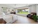 Serene main bedroom with large windows, wood floors, and a barn door leading to the bathroom at 1467 Battalion Dr, James Island, SC 29412