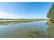 Scenic marsh view showcasing calm waters and shoreline vegetation near residential area at 1467 Battalion Dr, James Island, SC 29412