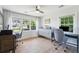Bright home office with modern furniture, large windows, and a serene view at 1467 Battalion Dr, James Island, SC 29412