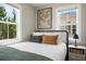 Comfortable bedroom with warm light, a queen bed, and natural light at 15 H Street St, Charleston, SC 29403