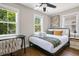 Comfortable bedroom with warm light, a queen bed, a desk and a cozy chair at 15 H Street St, Charleston, SC 29403