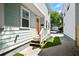 Inviting front porch with a peach colored door, leading to a well-maintained walkway at 15 H Street St, Charleston, SC 29403