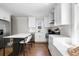 Bright, updated kitchen features white cabinets, stainless steel appliances, and a functional island with seating at 15 H Street St, Charleston, SC 29403