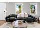 Inviting living room with a leather sofa, modern decor, and hardwood floors at 15 H Street St, Charleston, SC 29403