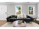 Cozy living room featuring a leather sofa, modern decor, and lots of natural light at 15 H Street St, Charleston, SC 29403