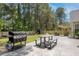 Spacious backyard featuring a grill, picnic table, seating, playset, and lush greenery at 1525 Cypress Pointe Dr, Mount Pleasant, SC 29466