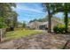 Large backyard with patio, grill, screened porch, play equipment, and partially wooded area at 1525 Cypress Pointe Dr, Mount Pleasant, SC 29466