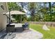 Cozy patio with umbrella table, outdoor seating, and partially fenced yard at 1525 Cypress Pointe Dr, Mount Pleasant, SC 29466
