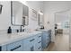 Bright bathroom with light blue double vanity, matte black hardware, and hardwood floors at 1525 Cypress Pointe Dr, Mount Pleasant, SC 29466