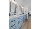 Bright bathroom with light blue double vanity, matte black hardware, and hardwood floors at 1525 Cypress Pointe Dr, Mount Pleasant, SC 29466
