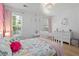 Bright bedroom with modern chandelier, white dresser, and hardwood floors at 1525 Cypress Pointe Dr, Mount Pleasant, SC 29466