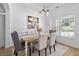 Dining room with modern chandelier, neutral decor, and large window with natural light at 1525 Cypress Pointe Dr, Mount Pleasant, SC 29466