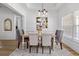Dining room with modern chandelier, neutral decor, and large window with natural light at 1525 Cypress Pointe Dr, Mount Pleasant, SC 29466