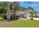 Charming single-story home featuring well-kept landscaping with palm trees and a two-car garage at 1525 Cypress Pointe Dr, Mount Pleasant, SC 29466