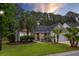 Charming single-story home featuring well-kept landscaping with palm trees and a two-car garage at 1525 Cypress Pointe Dr, Mount Pleasant, SC 29466