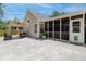 Backyard patio with seating and an umbrella table, screened porch, and siding at 1525 Cypress Pointe Dr, Mount Pleasant, SC 29466