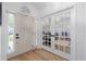 Bright foyer with hardwood floors, white trim and molding, and French doors leading into another room at 1525 Cypress Pointe Dr, Mount Pleasant, SC 29466
