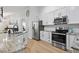 Modern kitchen featuring stainless steel appliances, granite countertops, and white cabinets at 1525 Cypress Pointe Dr, Mount Pleasant, SC 29466