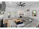 Open concept living room with hardwood floors, gray sectional, fireplace, and easy access to back patio at 1525 Cypress Pointe Dr, Mount Pleasant, SC 29466