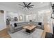 Open concept living room with large sectional, fan, and seamless flow to adjacent dining and kitchen areas at 1525 Cypress Pointe Dr, Mount Pleasant, SC 29466