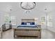 Bright main bedroom with vaulted ceiling, chandelier, hardwood floors, and plenty of natural light at 1525 Cypress Pointe Dr, Mount Pleasant, SC 29466