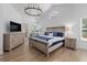 Large main bedroom with hardwood floors, vaulted ceiling, TV, and access to a private balcony at 1525 Cypress Pointe Dr, Mount Pleasant, SC 29466