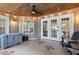 Relaxing screened porch with ceiling fan, recessed lights, and outdoor seating arrangement at 1525 Cypress Pointe Dr, Mount Pleasant, SC 29466