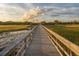 Take a calming stroll along the scenic wooden boardwalk at sunset at 1569 Red Tide Rd, Mount Pleasant, SC 29466