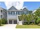 Charming two-story home with a two car garage and lush landscaping at 1569 Red Tide Rd, Mount Pleasant, SC 29466