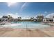 Enjoy this beautiful community pool with palm trees and gazebo coverings on a bright and sunny day at 1569 Red Tide Rd, Mount Pleasant, SC 29466