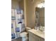 Standard bathroom featuring a vanity sink, toilet, and shower with nautical-themed curtain at 1600 Long Grove Dr # 411, Mount Pleasant, SC 29464