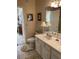 Bright bathroom featuring tiled floors, a decorative lamp, and a doorway leading to bedroom area at 1600 Long Grove Dr # 411, Mount Pleasant, SC 29464