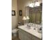Clean bathroom featuring a white vanity, neutral walls with framed art, and an decorative shower curtain at 1600 Long Grove Dr # 411, Mount Pleasant, SC 29464