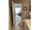 A bathroom with tiled floors that opens to a bedroom area with an open window at 1600 Long Grove Dr # 411, Mount Pleasant, SC 29464