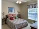 Inviting bedroom featuring a cozy bed with colorful patchwork quilt, complemented by bright, natural lighting at 1600 Long Grove Dr # 411, Mount Pleasant, SC 29464