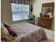 Charming bedroom with a colorful bedspread, window view, and a vintage wooden dresser, creating a cozy retreat at 1600 Long Grove Dr # 411, Mount Pleasant, SC 29464