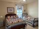 Comfortable bedroom featuring two beds with nautical-themed quilts and decor at 1600 Long Grove Dr # 411, Mount Pleasant, SC 29464