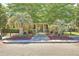 Charming clubhouse entrance with palm trees, brick pathway and vibrant flowerbeds at 1600 Long Grove Dr # 411, Mount Pleasant, SC 29464