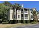 Multi-story building with wood siding, screened in balconies, and well-maintained landscaping at 1600 Long Grove Dr # 411, Mount Pleasant, SC 29464