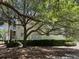 Residential building with light siding surrounded by hedges and a shady tree at 1600 Long Grove Dr # 411, Mount Pleasant, SC 29464