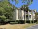 Attractive condo building featuring screened porches, manicured landscaping and a palm tree at 1600 Long Grove Dr # 411, Mount Pleasant, SC 29464